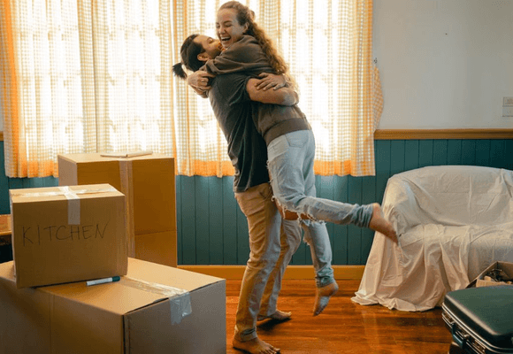 Couple unpacking boxes in new home